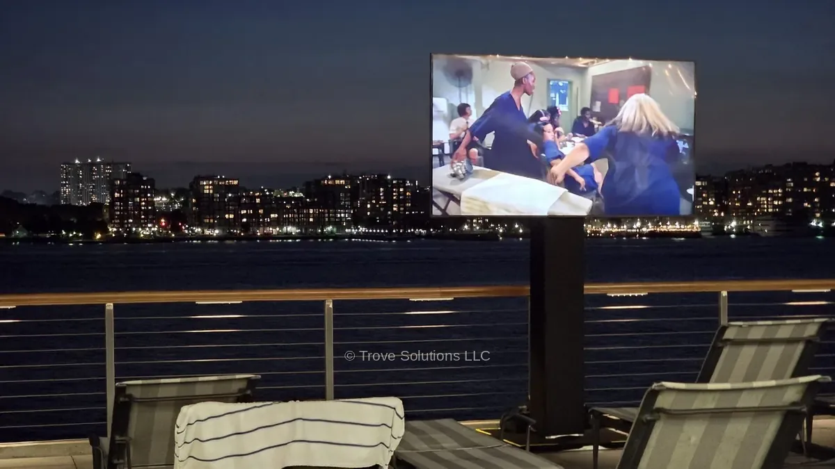 TV on mobile rolling stand outdoor installation Manhattan pier