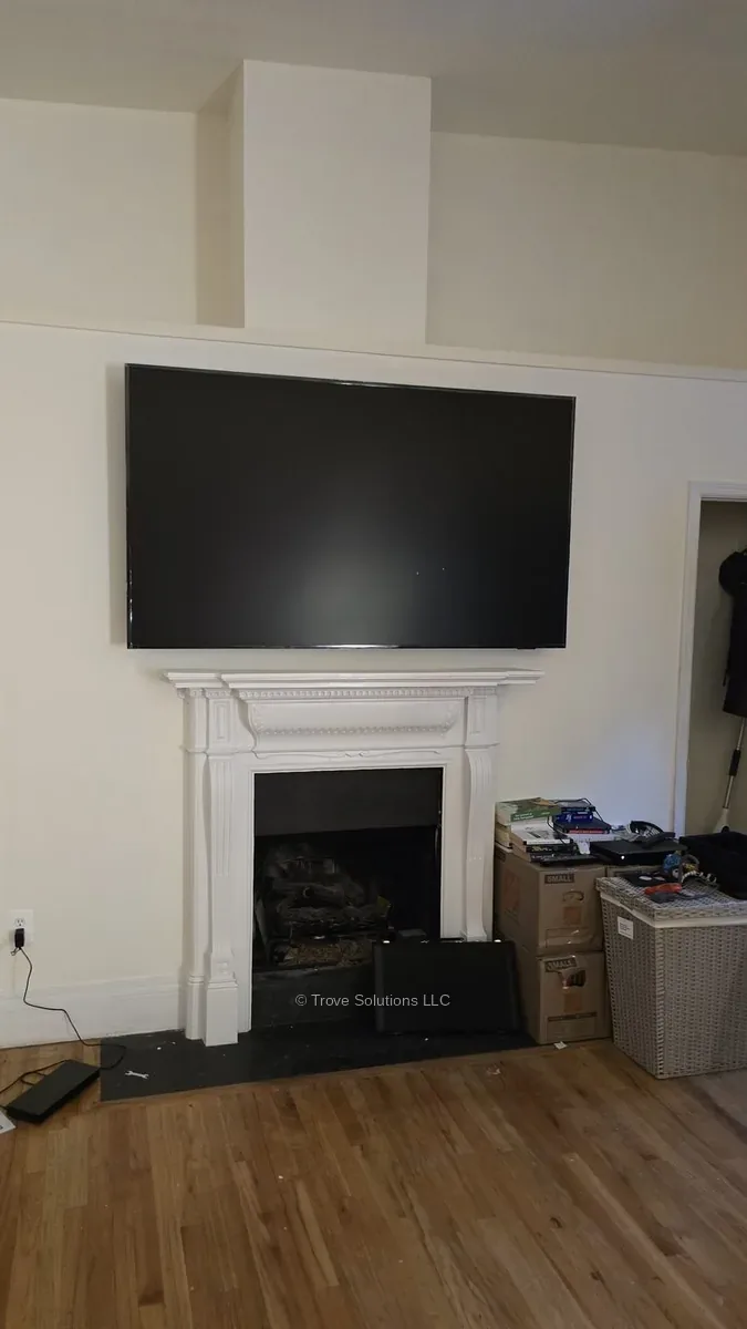 TV mounted above fireplace Manhattan apartment