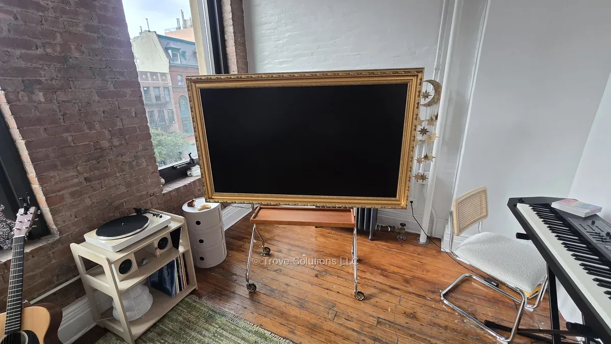 Frame TV on easel stand Manhattan loft — gold ornate frame