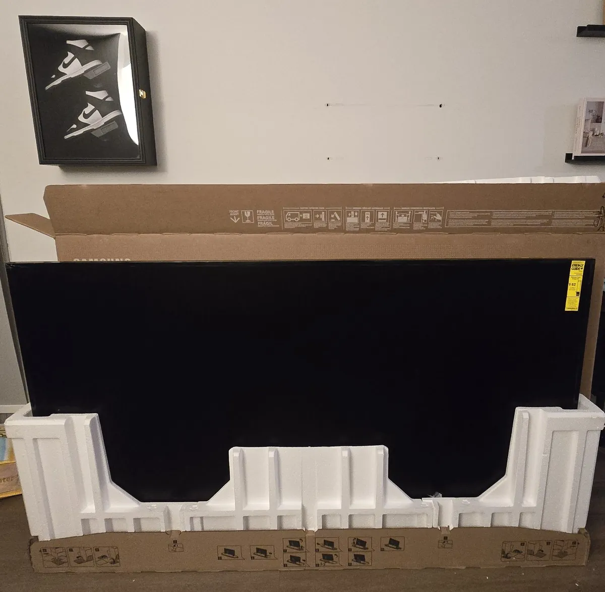 Samsung Frame TV standing in its opened box with the foam inserts