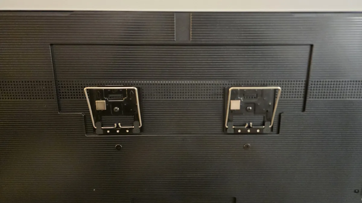 Close-up of the two Hisense mounting brackets on the back of the TV