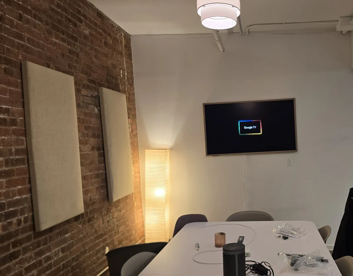 Finished 55-inch Hisense CanvasTV with a wood-look frame in an office meeting room