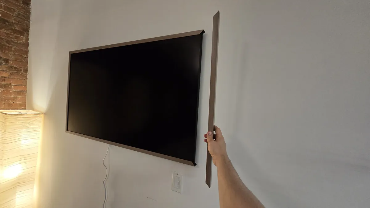 Hanging the last side piece of the frame on the Hisense CanvasTV
