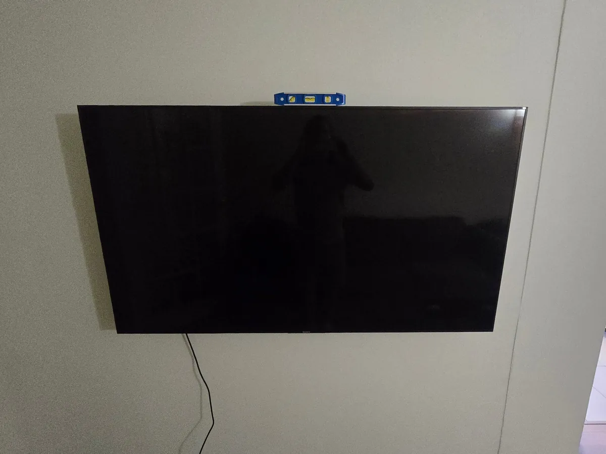 Sony TV flat-mounted on drywall, level on top