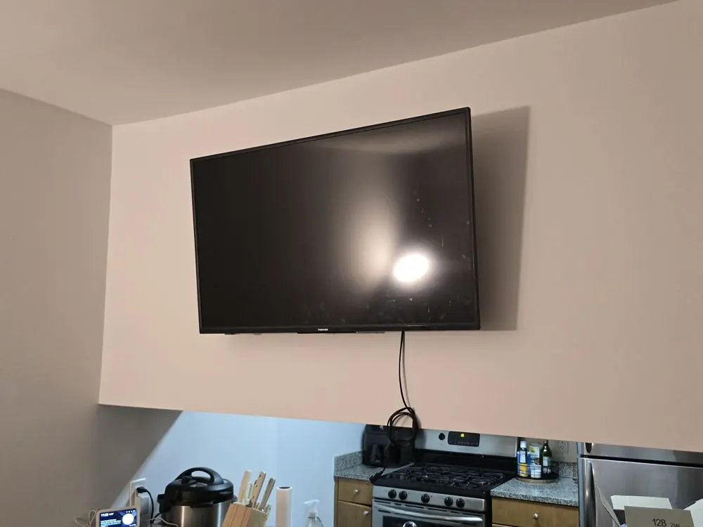 TV mounted above a kitchen pass-through