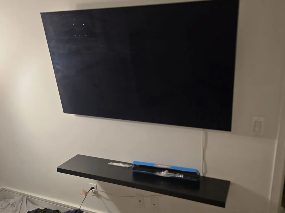 Low-profile TV mount with a floating shelf below